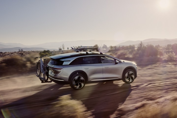 Rear three quarter view of a Lucid Gravity electric SUV with a bike rack and roof rack.