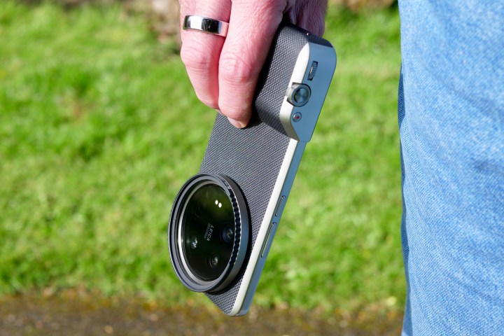 A person holding the Xiaomi 14 Ultra, with the Photography Kit fitted.