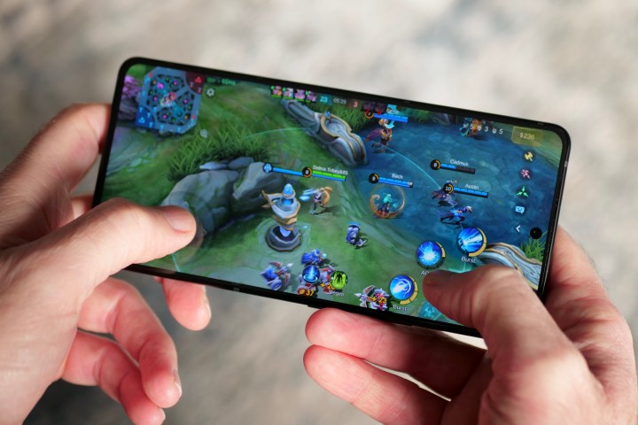 A person playing a game on the Asus ROG Phone 9 Pro.