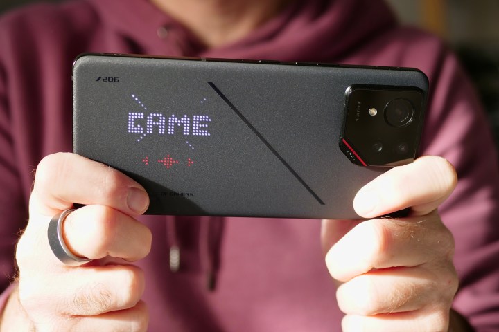 A person holding the Asus ROG Phone 9 Pro.