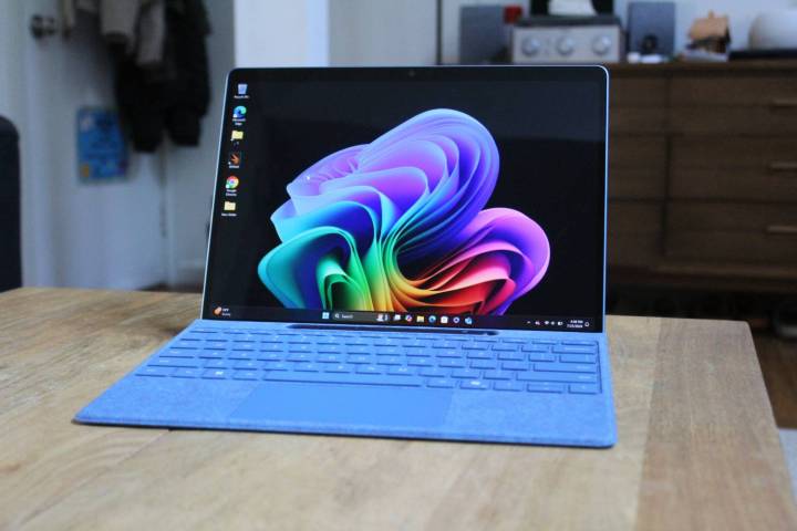 The Surface Pro 11 on a brown table.