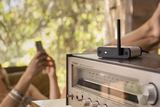 A person listening to music with the Audioengine B-Fi.