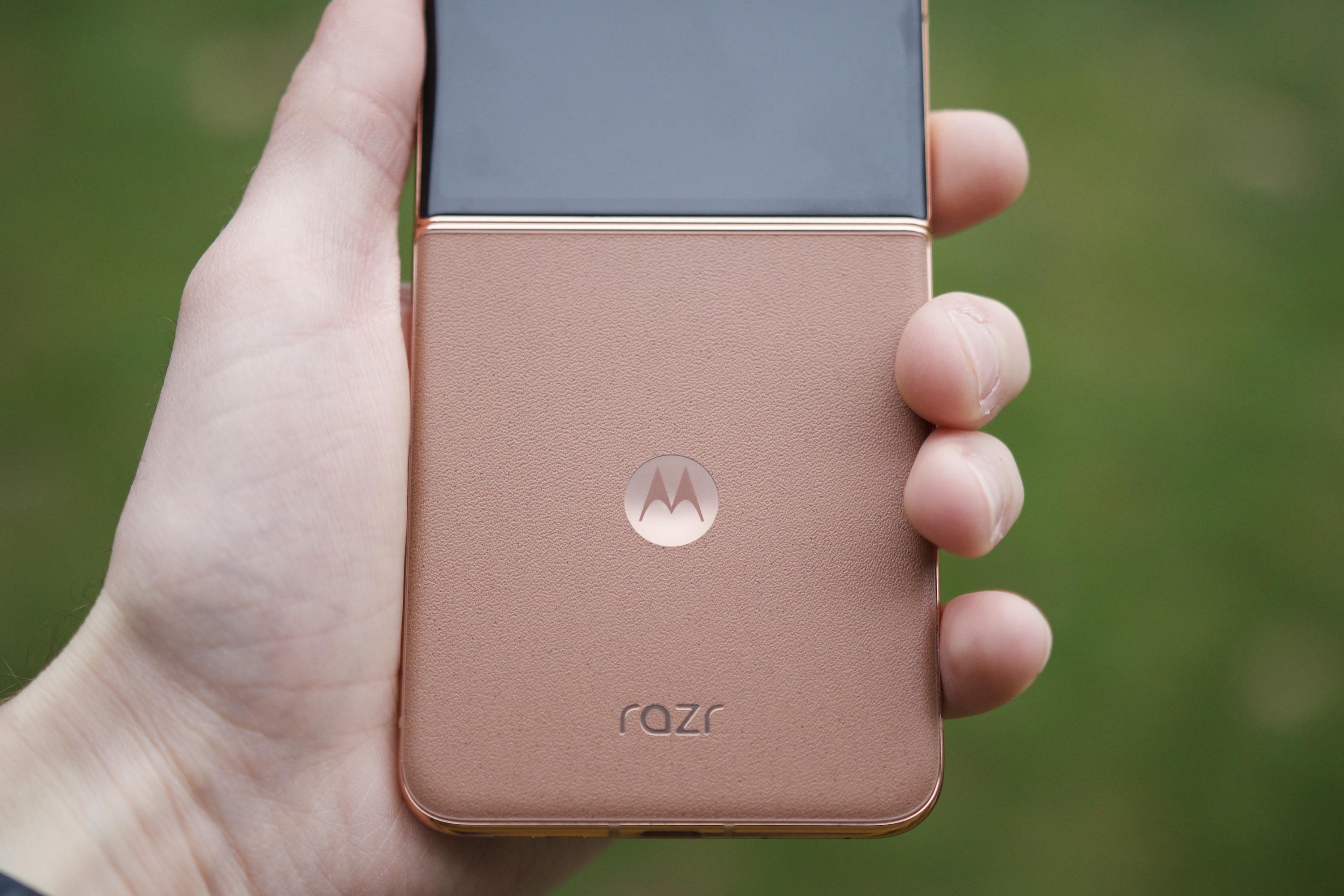 alt: Someone holding the Mocha Mousse Motorola Razr Plus open, demonstrating its usability and stylish design.