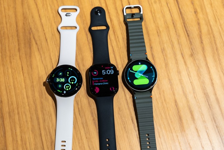 Pixel Watch 3, Apple Watch Series 10, and Galaxy Watch 7 on a table.