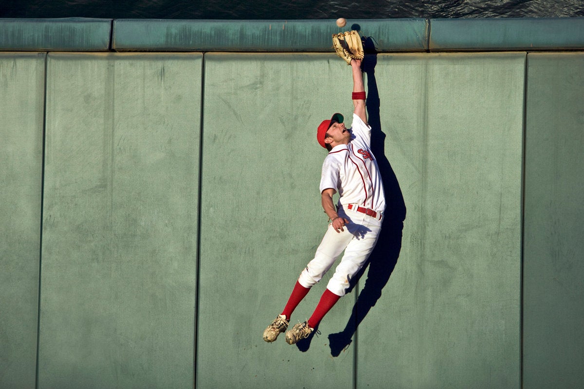 alt text: Baseball player making a diving catch.