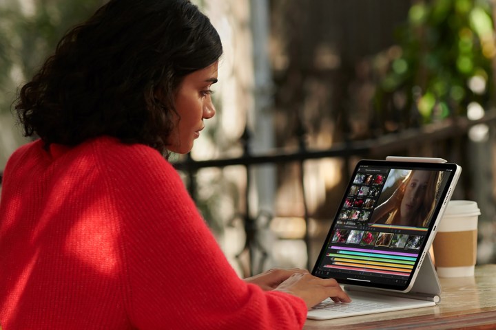 alt text: A woman using an iPad Pro for work.