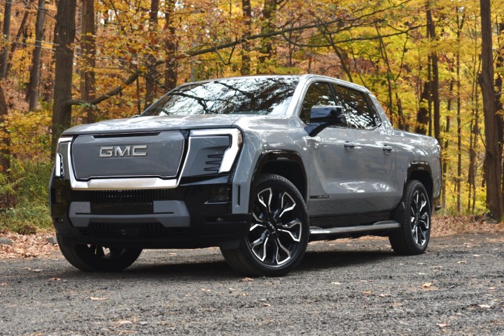 alt: Front view of the 2024 GMC Sierra EV highlighting its futuristic design and illuminated grille.