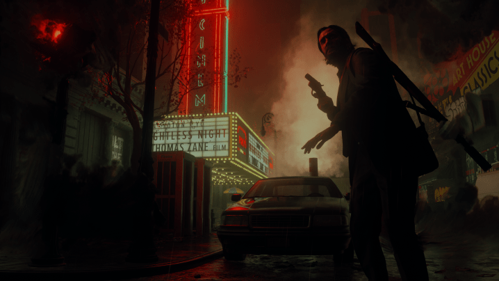 Alan Wake stands in front of a movie theater in Alan Wake 2.