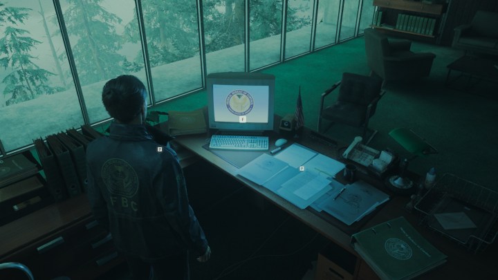 Agent Estevez in Alan Wake 2 looking at a computer.