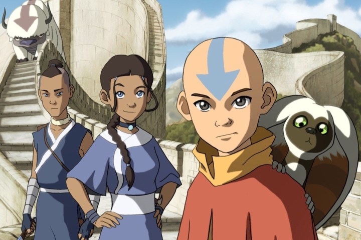 Sokka, Katara, and Aang standing and looking at the camera. Momo is on Aang