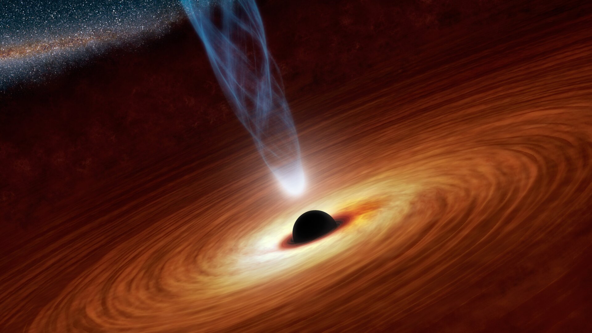 An artist’s concept of a supermassive black hole, surrounded by a swirling accretion disk, and emitting a powerful jet of particles.