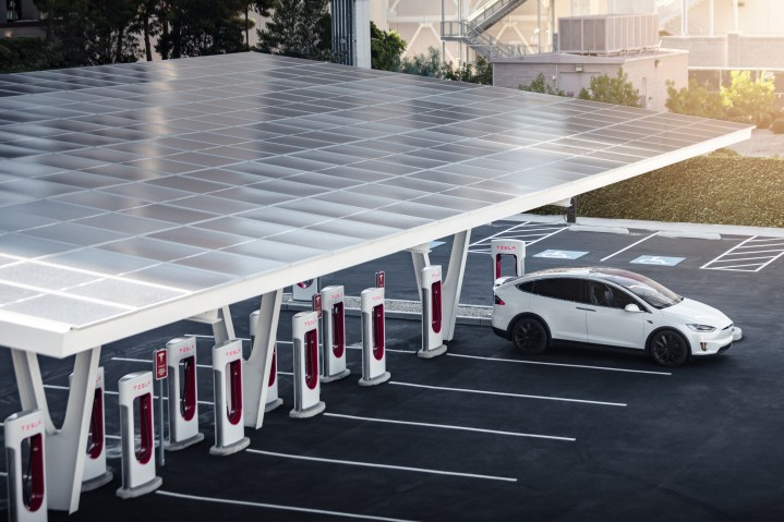 alt text: A Tesla vehicle charges at a Supercharger station.