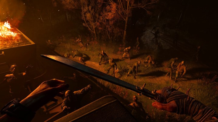 A crowd of zombies lit by a fire in Dying Light: The Beast.