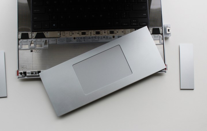 alt text: The touchpad and spacers removed from the Framework Laptop 16, showcasing its modular design.