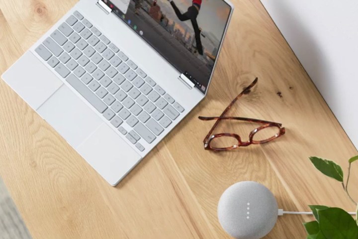 The Pixelbook on a table next to a pair of glasses.