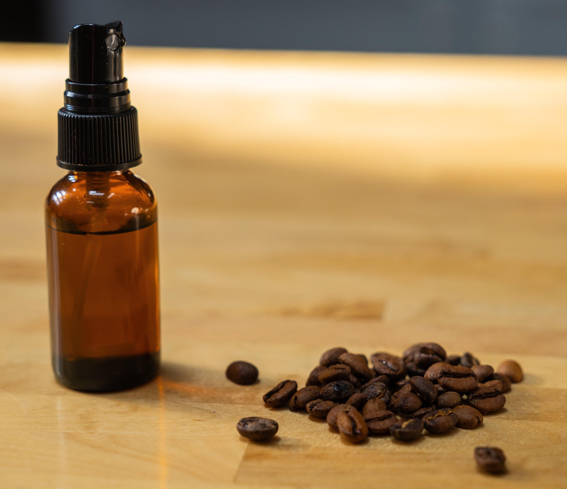 alt: Coffee beans being ground in a burr grinder. The grounds appear clumpy due to static electricity.