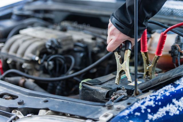 alt text: Jumper cables connected to a car battery