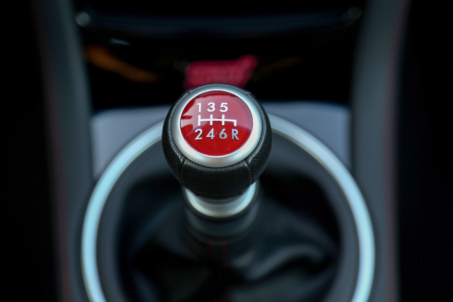 alt: Close-up of a gear shifter in a car with manual transmission