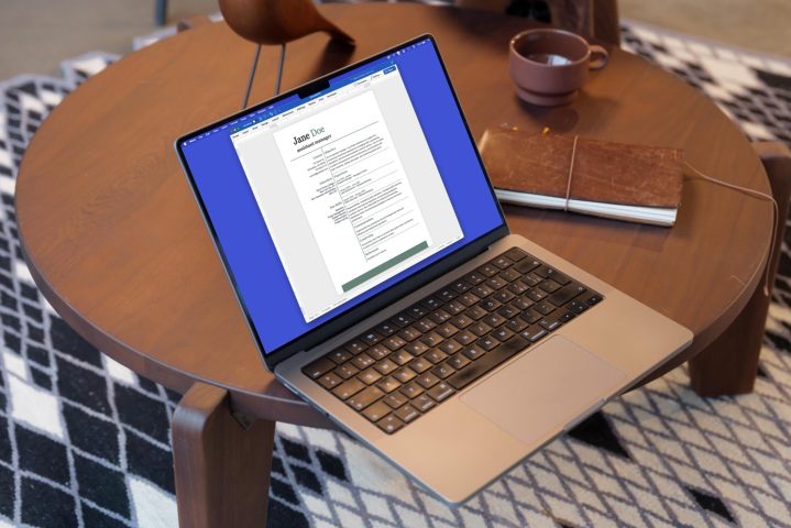 Word resume on a MacBook on a table.