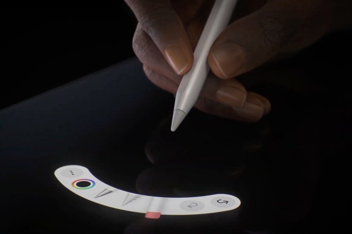 Hand holding Apple Pencil Pro showing squeeze gesture tool palette.