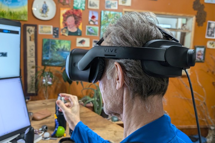 Someone using a Vive headset with their fingers pinching.