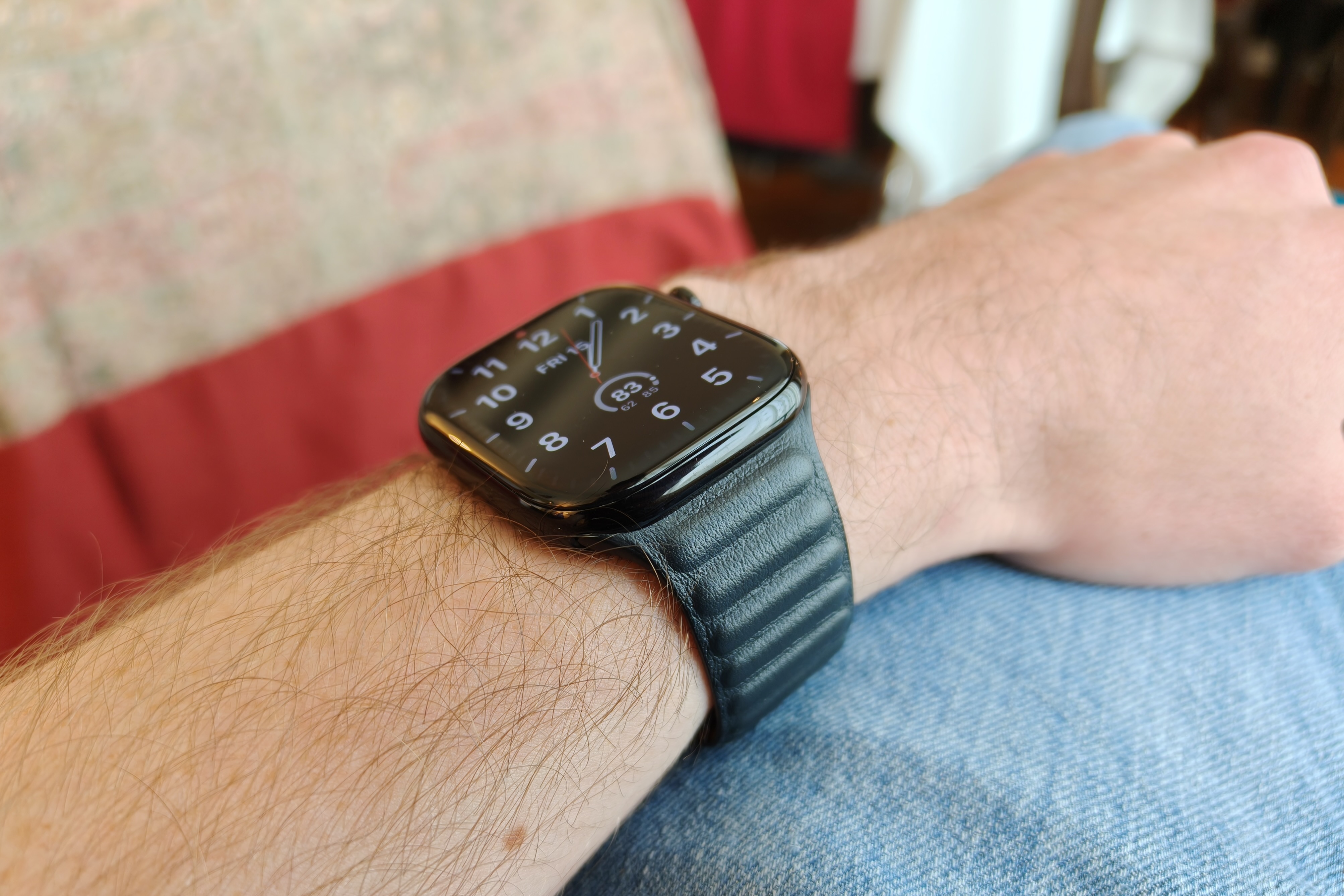 The Apple Watch Series 10, with a leather band, on someone