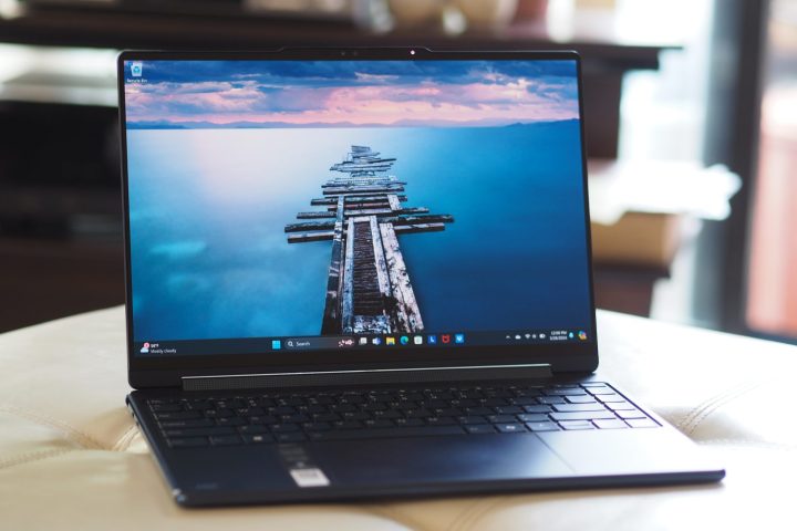 alt text: Lenovo Yoga 9i Gen 9 laptop in cosmic blue, angled view showcasing the display and keyboard.