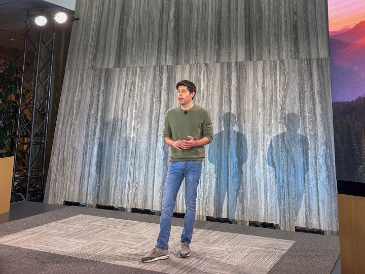 OpenAI CEO Sam Altman standing on stage at a product event.