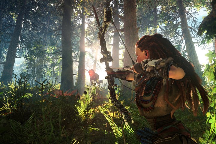 Aloy aiming her bow at a robot in a forest.