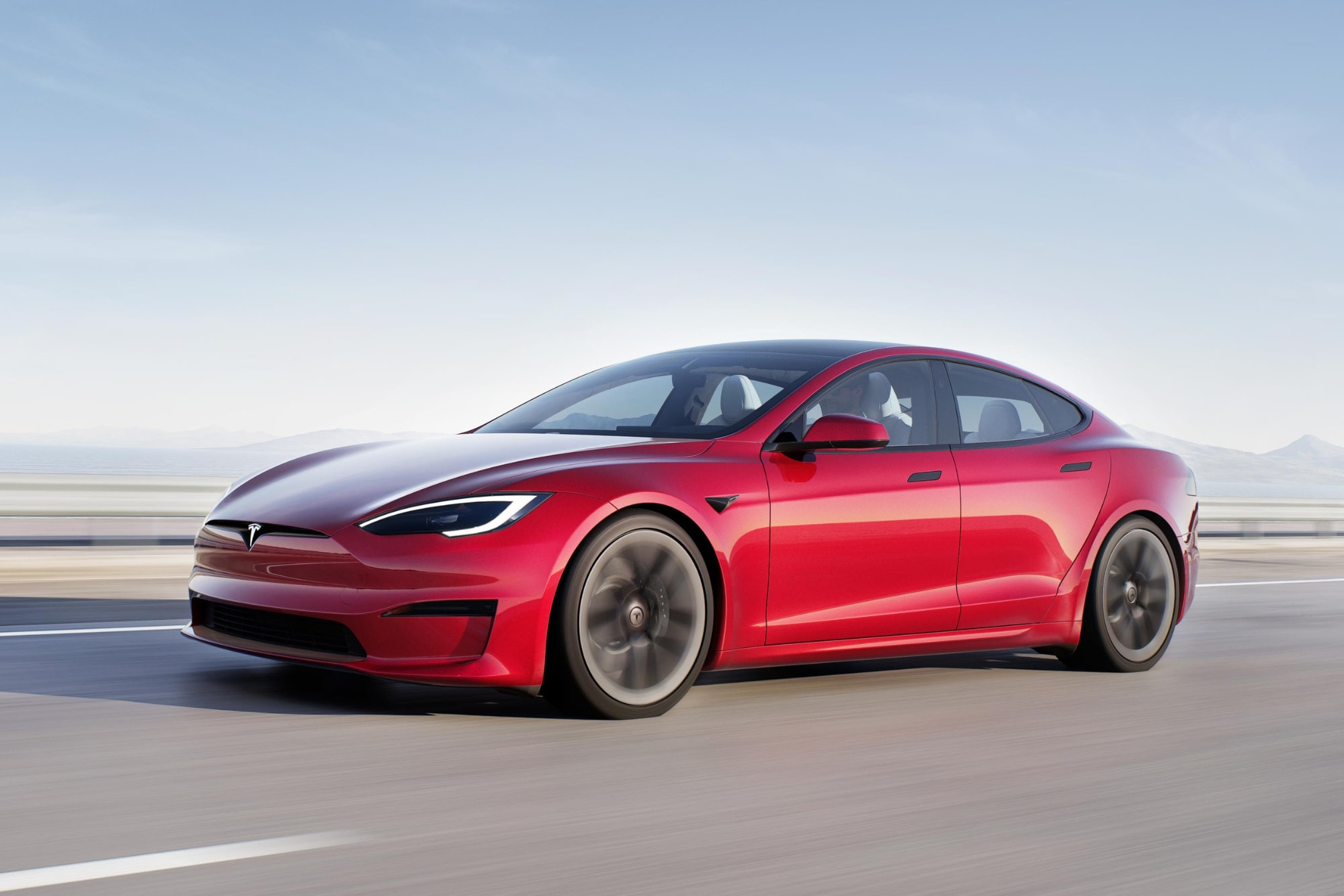 A Tesla Model Y is seen driving to the left.