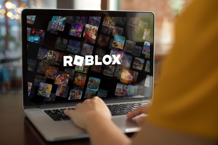 A laptop with a Roblox wallpaper.