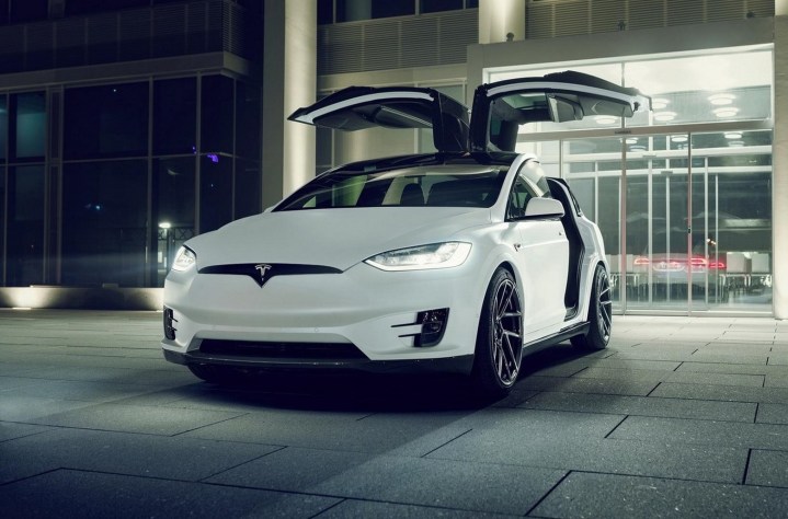 alt text: The exterior of a Tesla Model X, showcasing its distinctive falcon-wing doors.