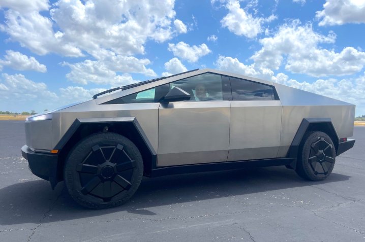 alt text: Tesla CEO Elon Musk sitting in a Cybertruck