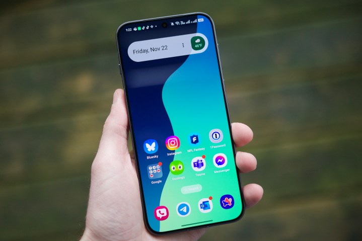 Someone holding the Oppo Find X8 with the screen on, showing the home screen.