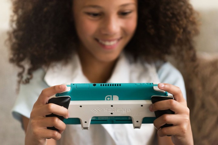 Alt: A blurred image of what appears to be the next-generation Nintendo Switch console, partially obscured by a Satisfye Zengrip 2 accessory.