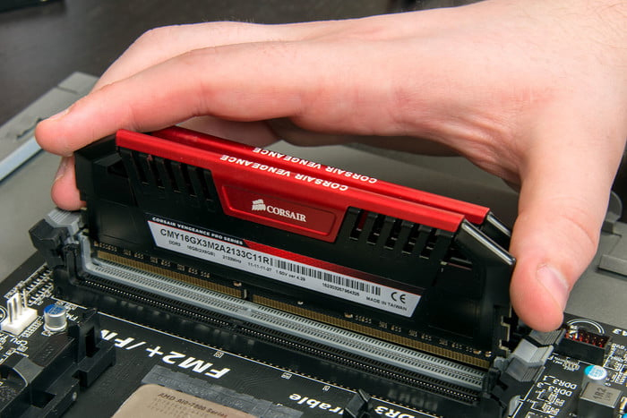 Opening RAM slots on a motherboard.