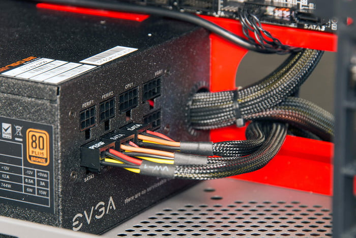 Connecting power supply cables inside the PC case.