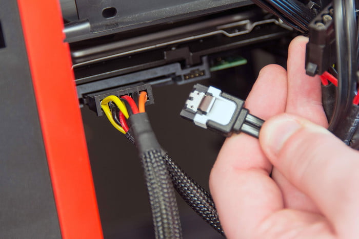 Connecting a SATA cable to a hard drive.