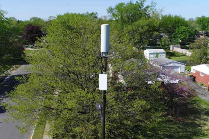 alt: A mmWave node attached to a telephone pole.