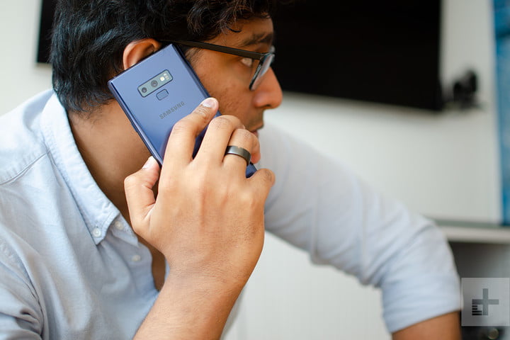 alt: A man talking on a smartphone.