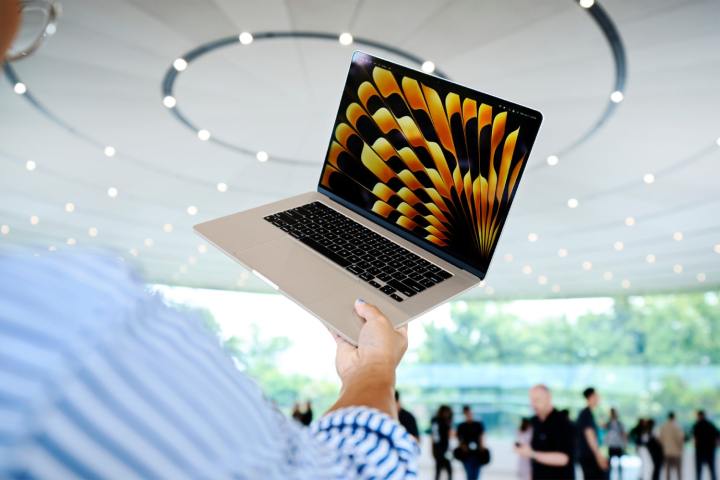 A person holds a MacBook Air at Apple