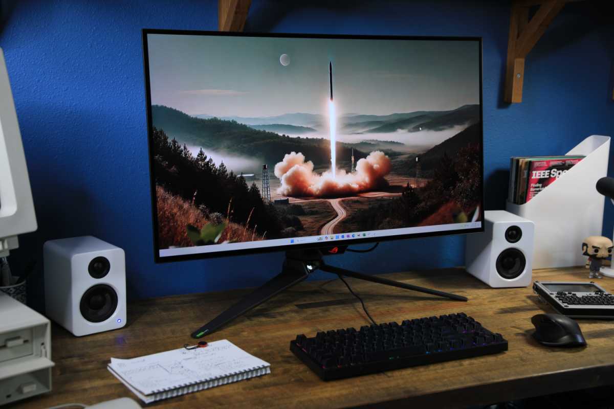 alt text: The Asus ROG Swift PG32UCDP displaying a vibrant HDR game scene.