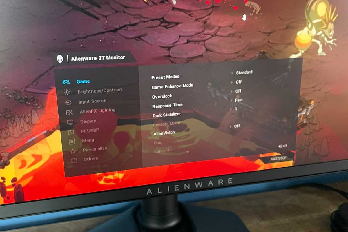 alt: Close-up of the Alienware AW2725QF's joystick control and on-screen display menu