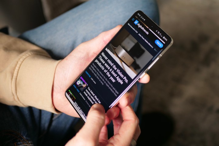 A person using the Chrome browser on the OnePlus 13.