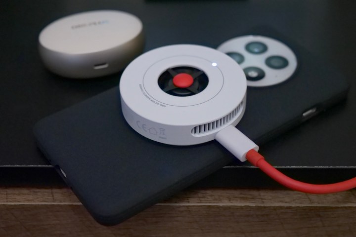 The AirVOOC wireless charger attached to the OnePlus 13.