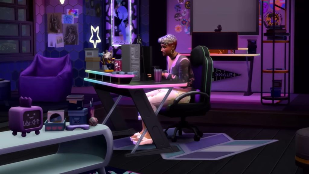 alt text: A Sim sits at a computer playing video games and streaming.