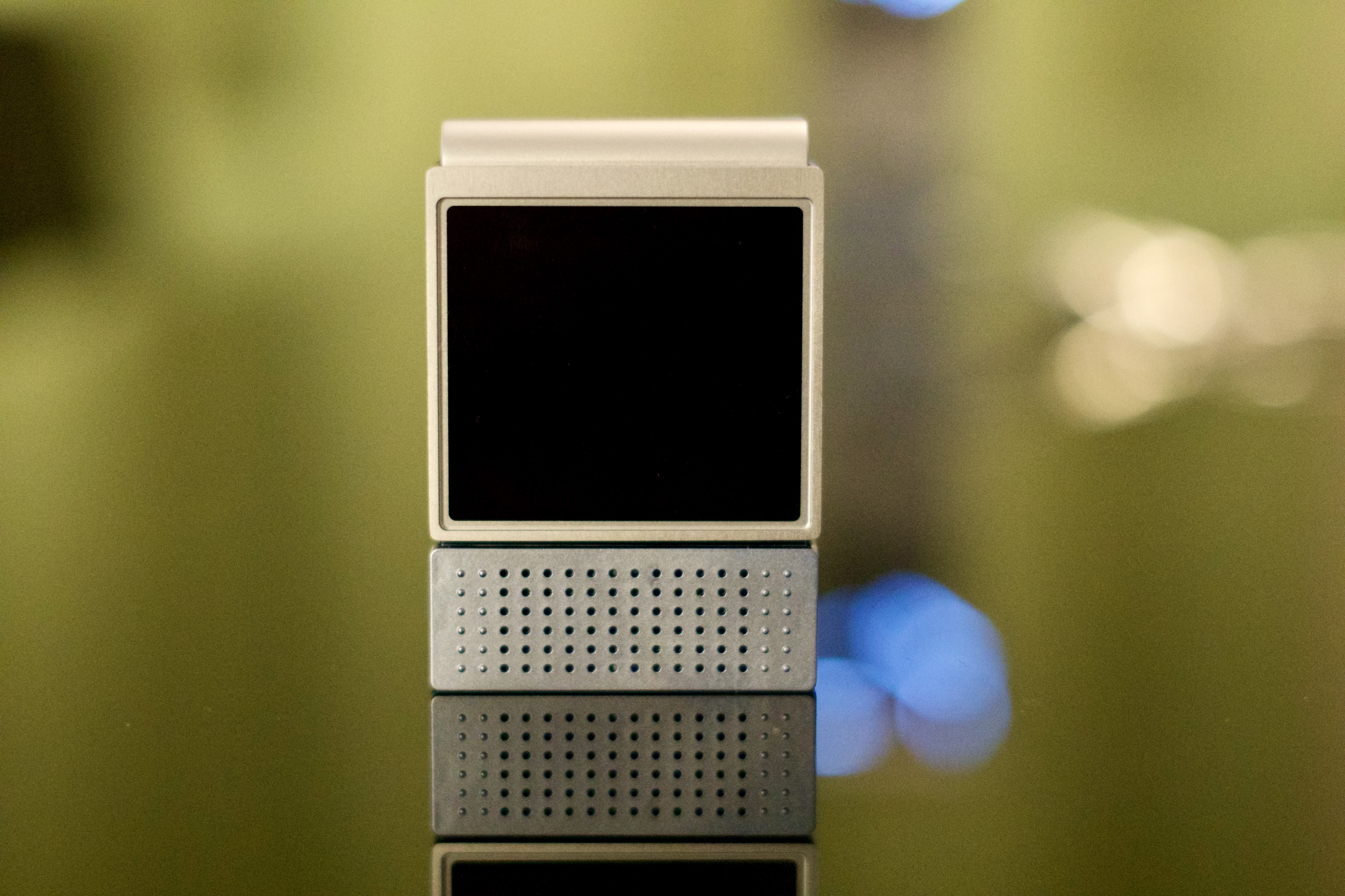 The Amazfit V1tal sitting on a table with its screen off.