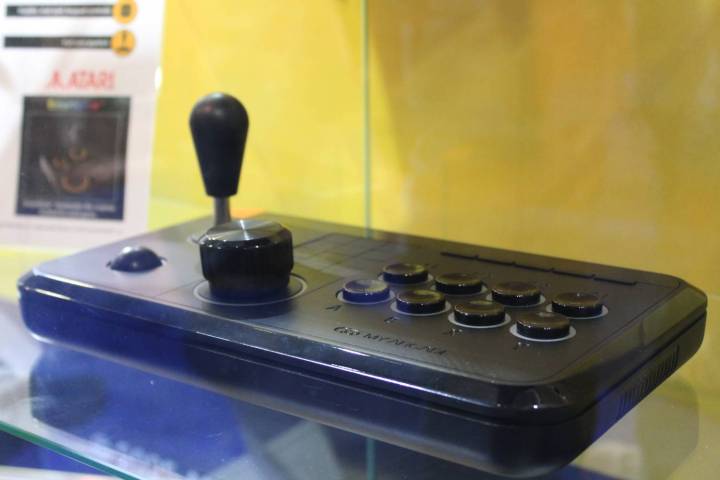 alt text: A person holding the Atari Gamestation Go, showcasing the handheld's comfortable grip.