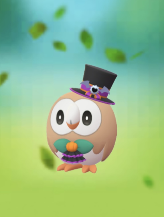 Rowlet wearing a top hat for Halloween in Pokémon Go