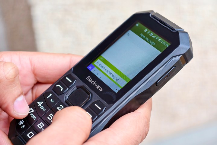 Person typing on the Blackview N1000 Rugged 4G Dumb Feature Phone T9 keyboard.